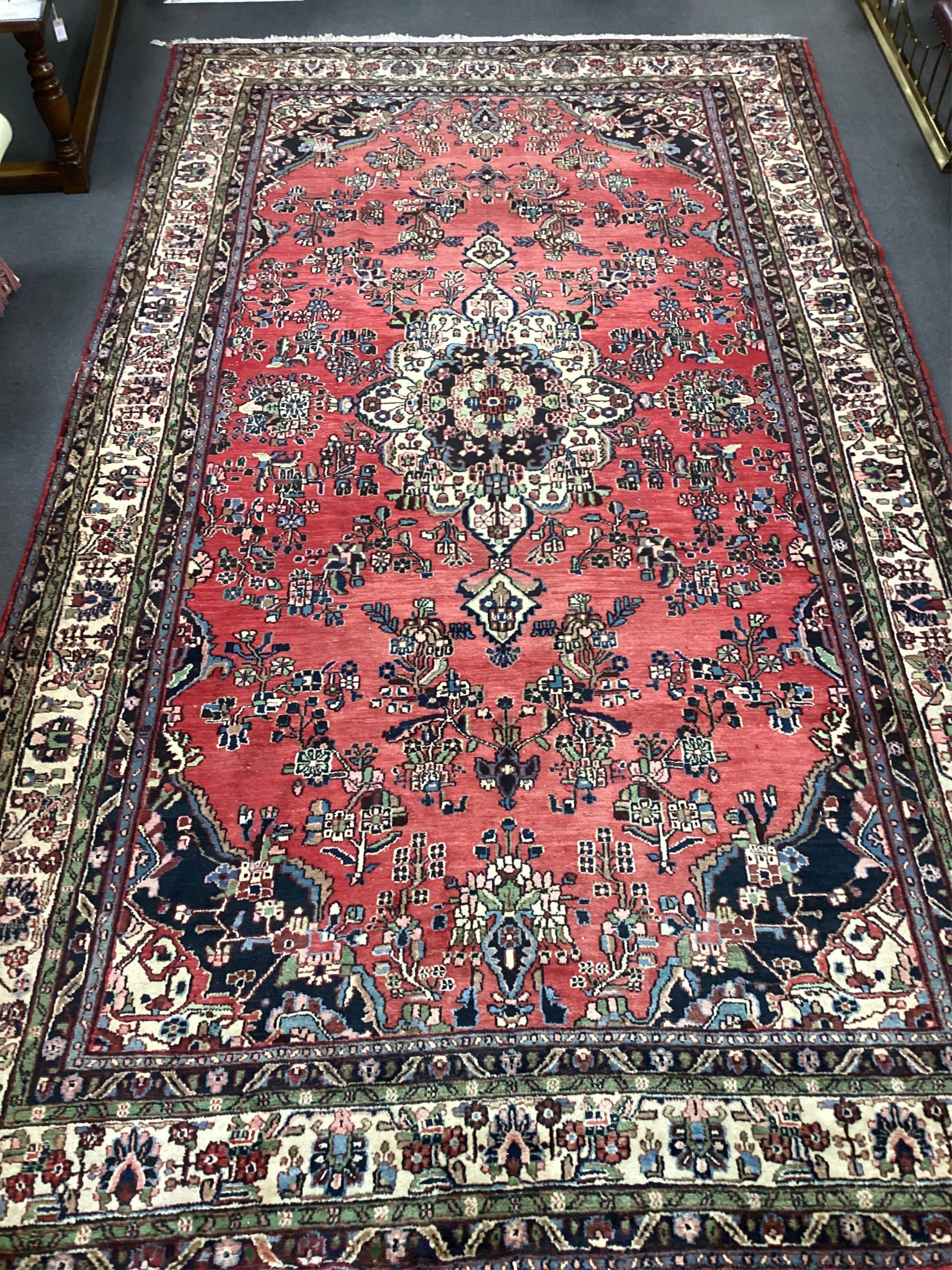 A Hamadan red ground carpet, 500 x 280cm. Condition - a couple of small patches of old moth damage